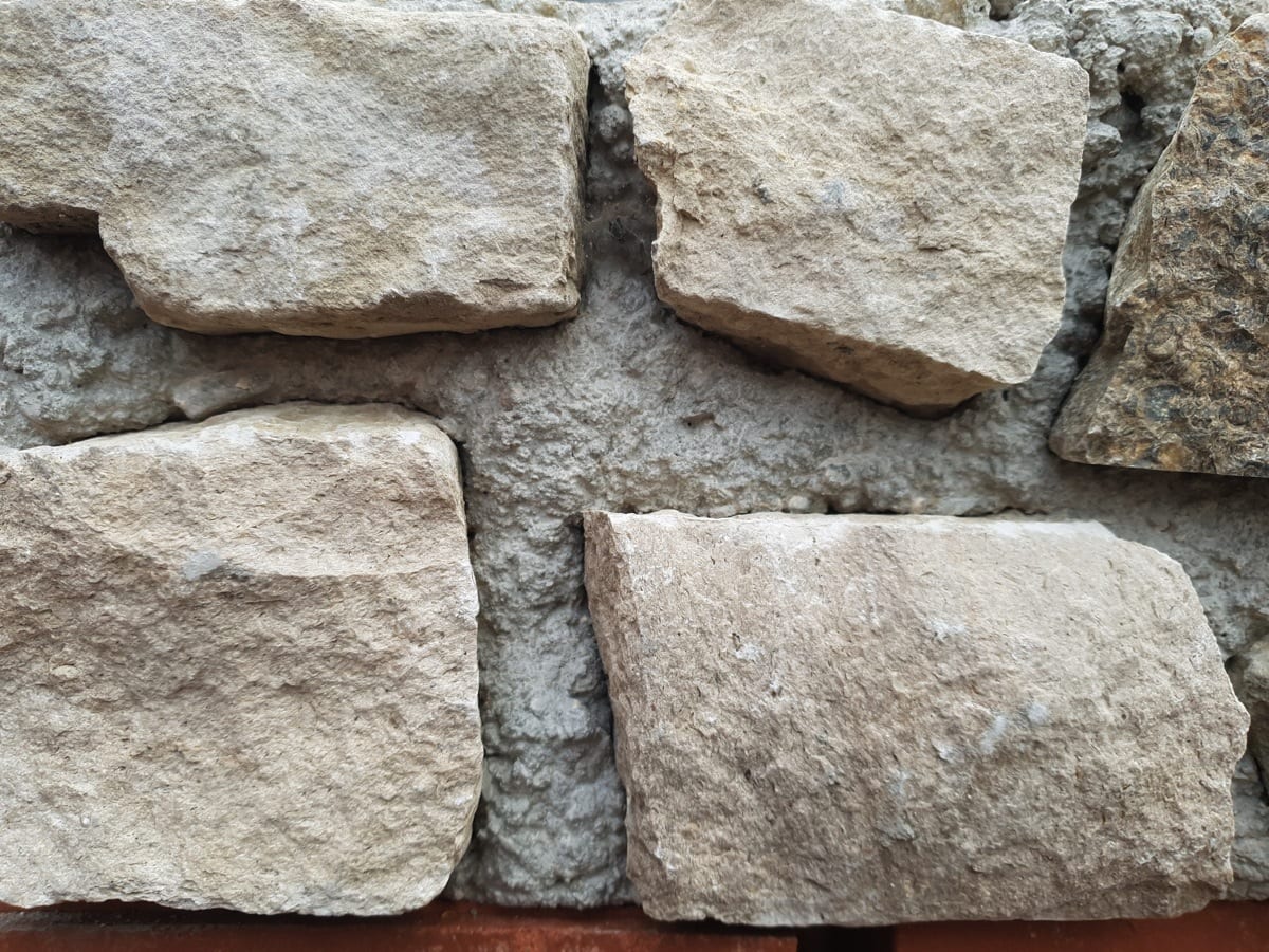 Close up photo of the purbeck stones in a stone block.