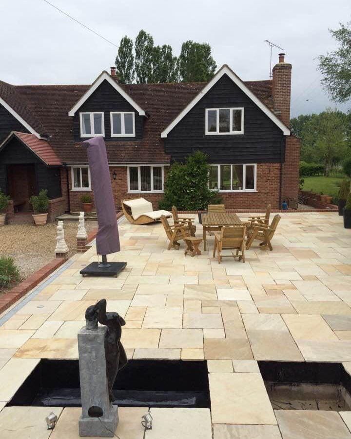 Photo of the Mint Fossil patio slabs in use in a garden.